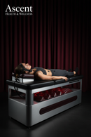 Person using cervical neck traction table for spine therapy - Ascent Health & Wellness